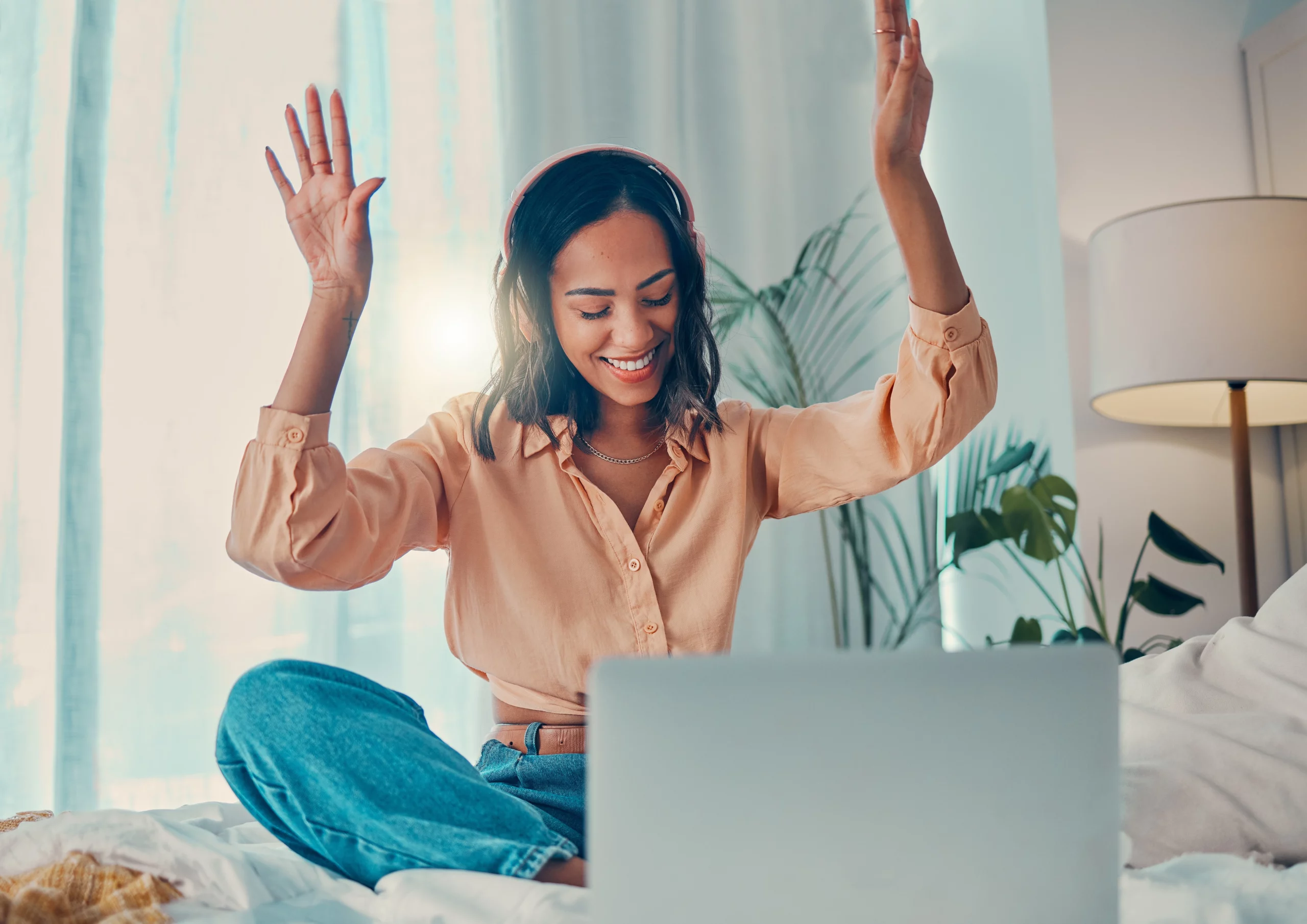 Woman on her laptop celebrating after being approved for a Perth Cash Loan from Swoosh Finance