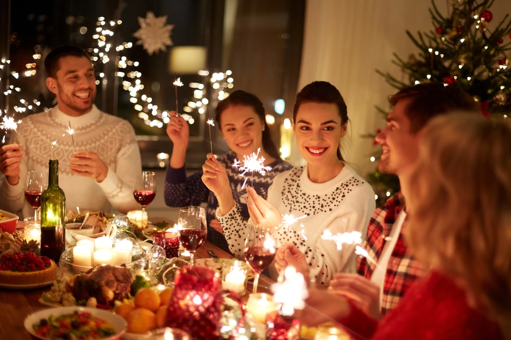Christmas Party with family with sparklers | Swoosh Finance