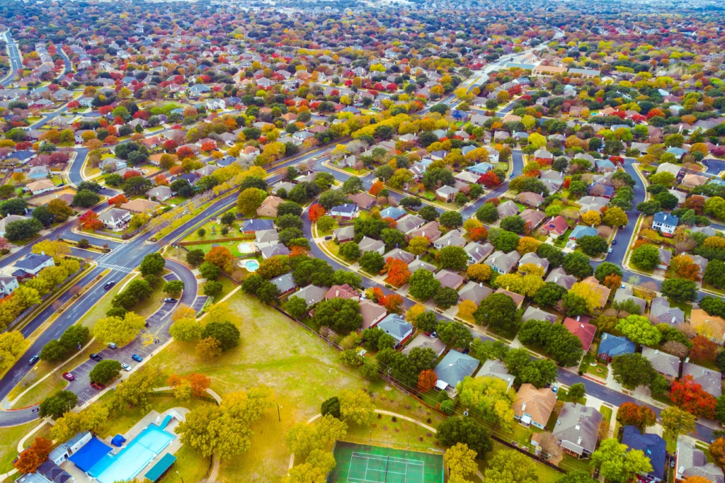 Bird's eye view of a suburb filled with tree-lined streets and houses
