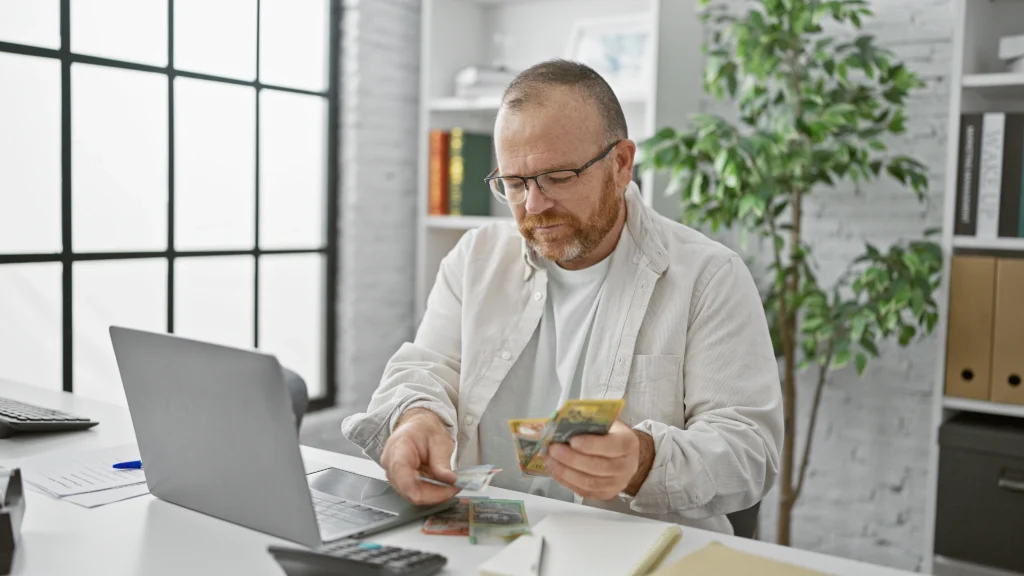 A man counts out the cash he got in his last tax return