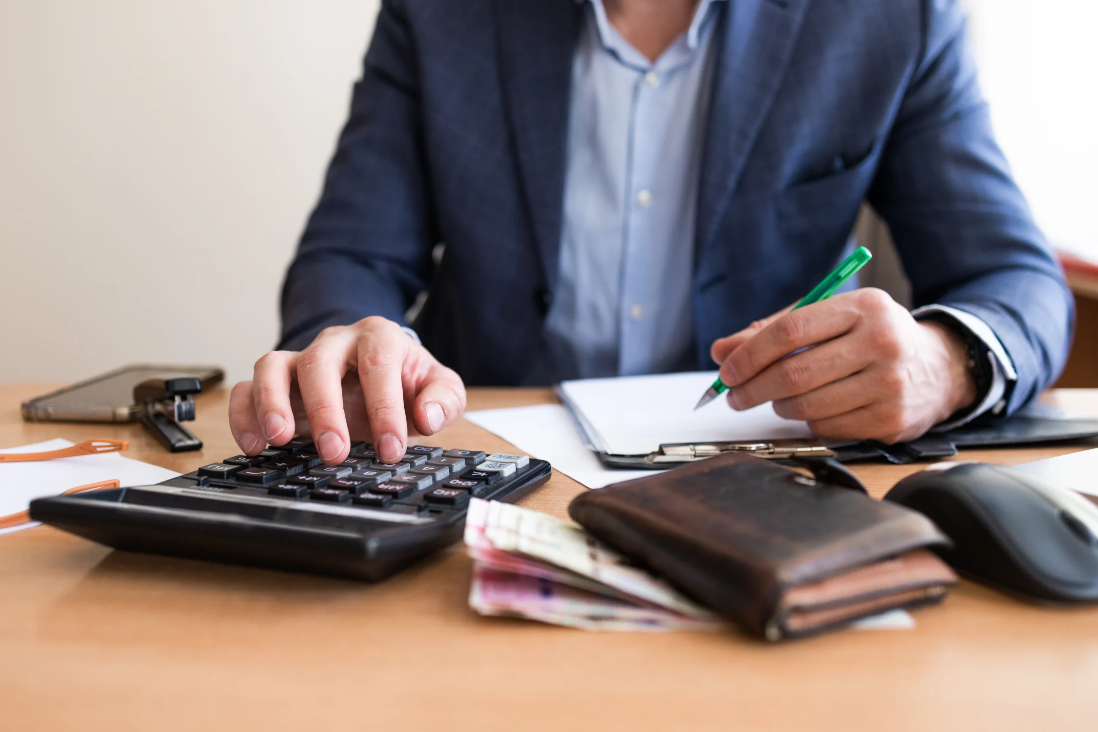 what is EOFY; what to do at the end of a tax year; man with calculator | Swoosh Finance