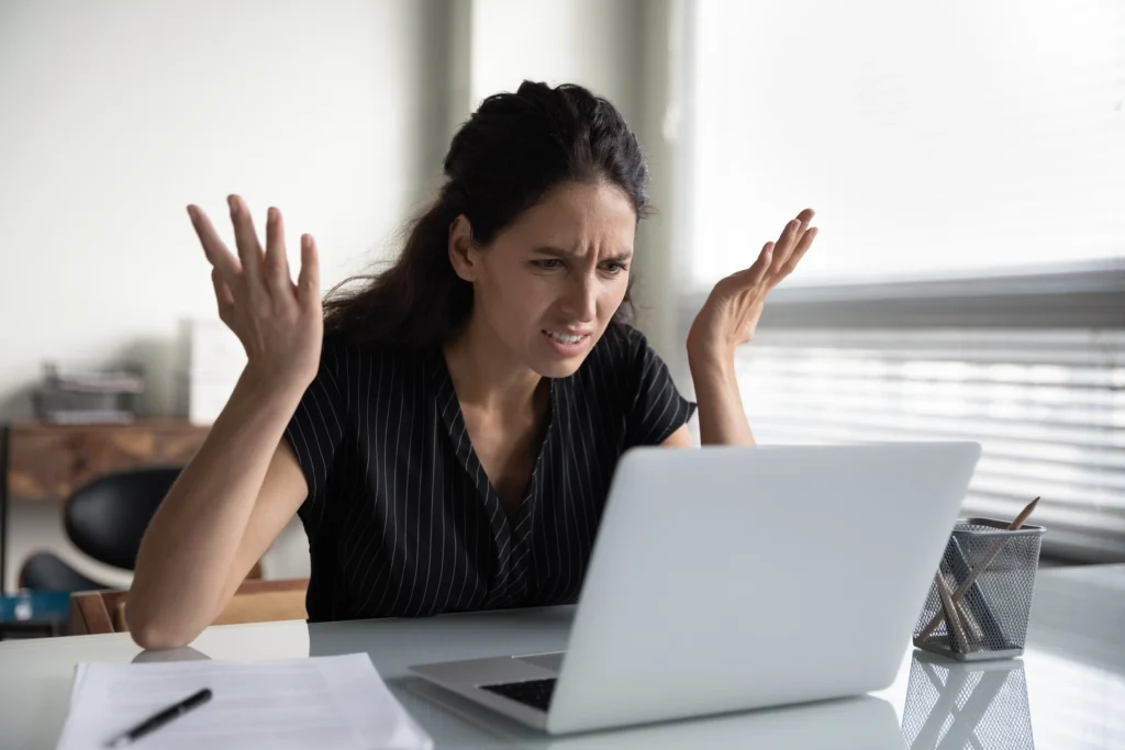 Frustrated women on her laptop | Swoosh Finance