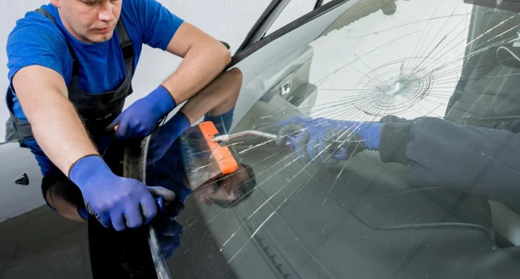 Workers replace cracked car windscreen
